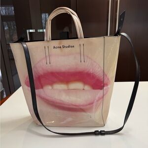Acne Studios Cream
and Pink Lip Print Tote print on both sides of bag.